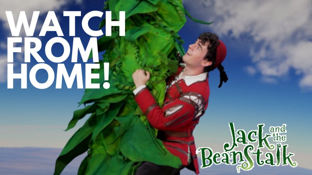 A photo of Jack, a white male with short dark hair wearing a red hat with a feather, red jacket over a white shirt with a collar climbing the beanstalk against a backdrop of a blue sky with fluffy white clouds. With the words watch from home in bold white font in the top left corner and the Jack and the Beanstalk logo in the bottom right corner.